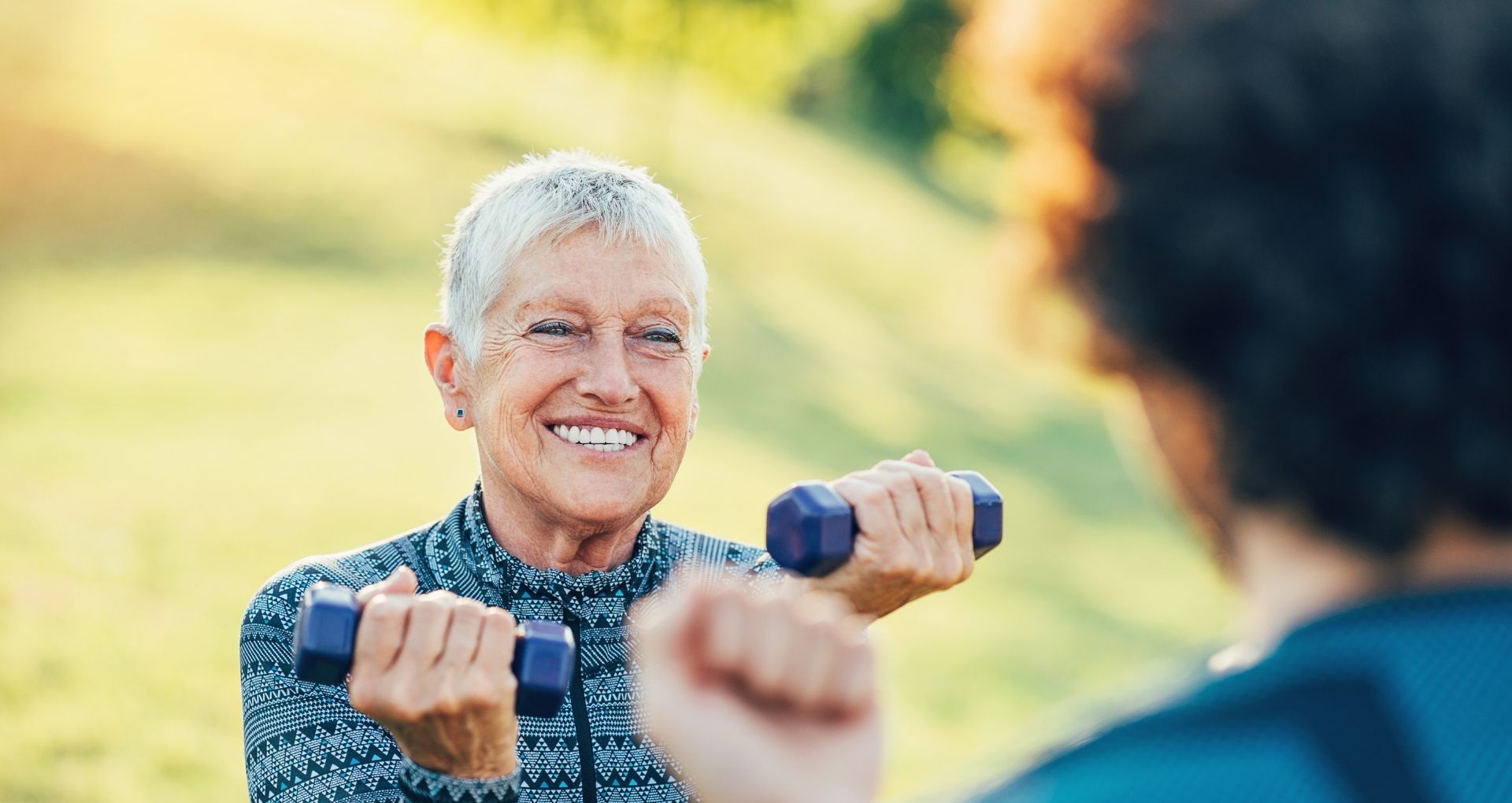  Aging Woman lifting weights for Healthy Aging Month regular eyes exams are important too